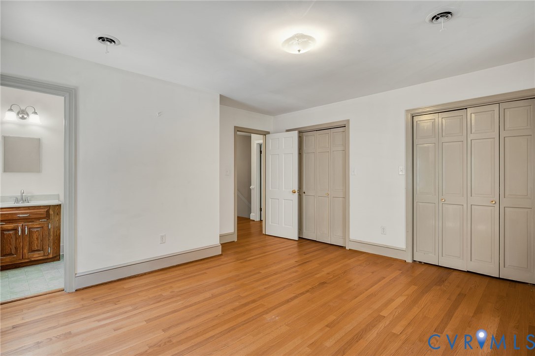 323 Church Street Wakefield, VA 23888 - Photo 23 of 50 an empty room with wooden floor cabinet and windows