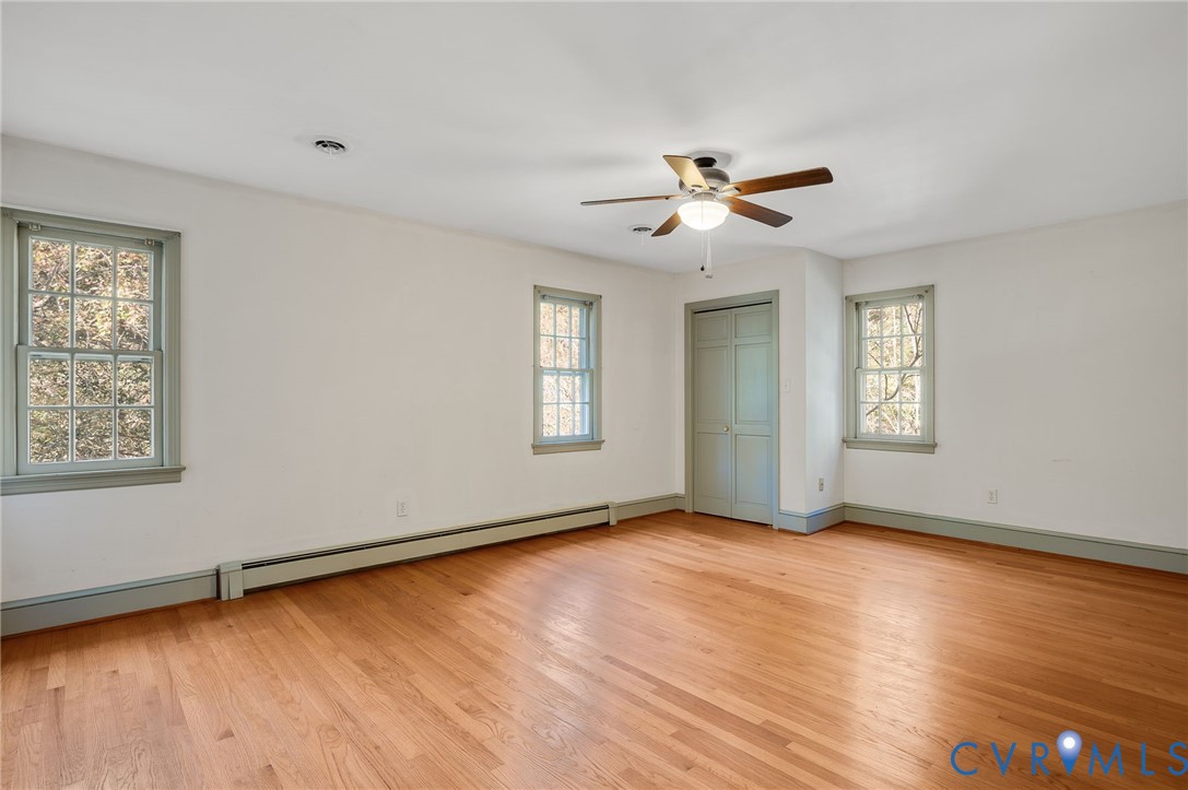 323 Church Street Wakefield, VA 23888 - Photo 26 of 50 a view of an empty room with a window and wooden floor