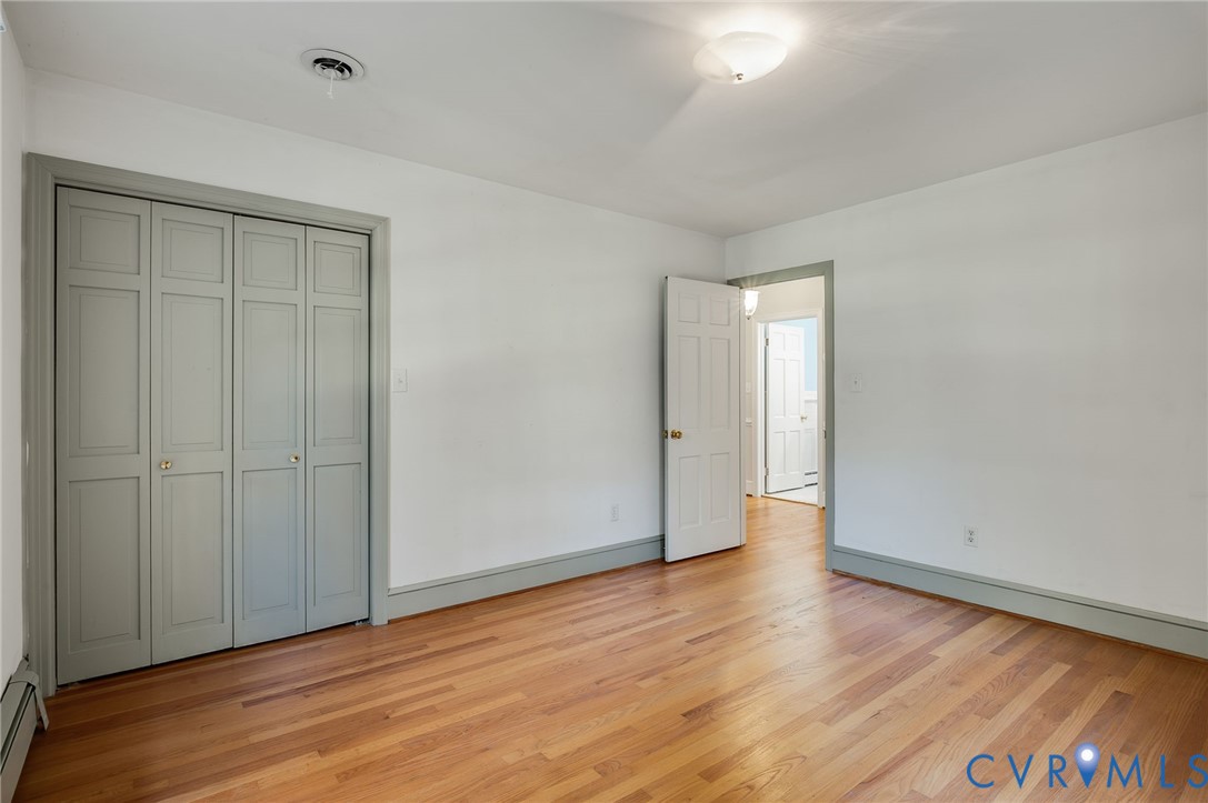 323 Church Street Wakefield, VA 23888 - Photo 28 of 50 a view of an empty room with wooden floor and a window