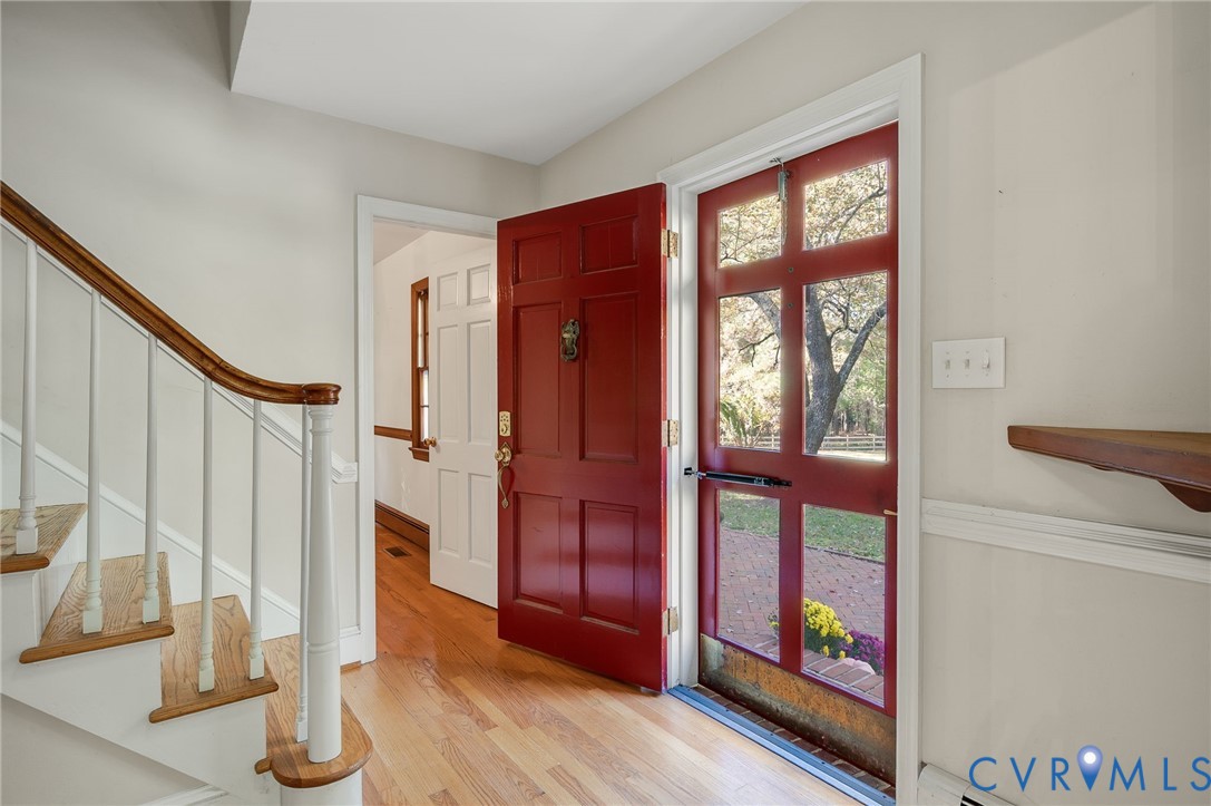 323 Church Street Wakefield, VA 23888 - Photo 3 of 50 a view of an entryway with wooden floor and door