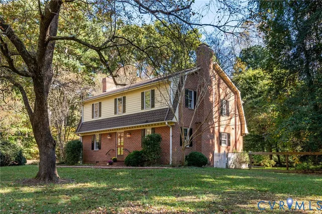 front view of a brick house with a yard