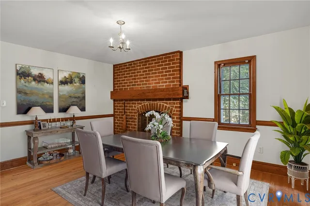 a dining room with furniture window and wooden floor
