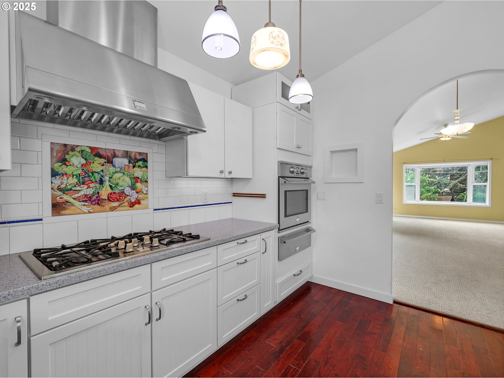 343 Hemlock Street Seaside, OR 97138 - Photo 4 of 17 a kitchen with stainless steel appliances a stove cabinets and a window