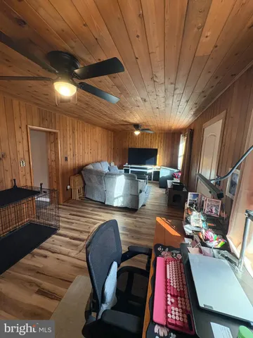 a bed room with a bed window and a flat screen tv