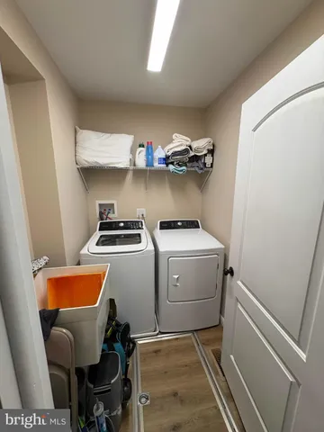 a bedroom with a bed ceiling fan and wooden floor