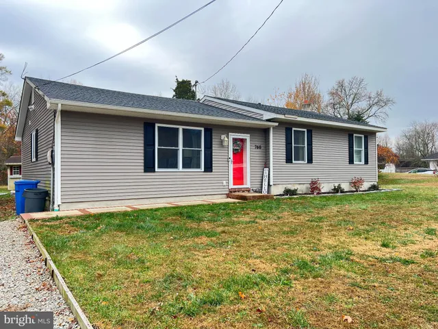 a front view of house with yard and outdoor seating