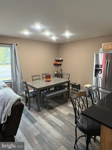 a room with furniture or chandelier and a wooden floor