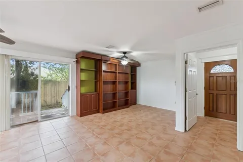a view of empty room with cabinet and floor to ceiling window