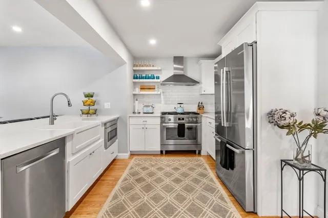 a kitchen with stainless steel appliances a refrigerator sink and stove
