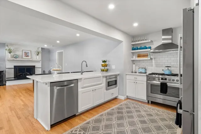 a kitchen with a stove cabinets and wooden floor