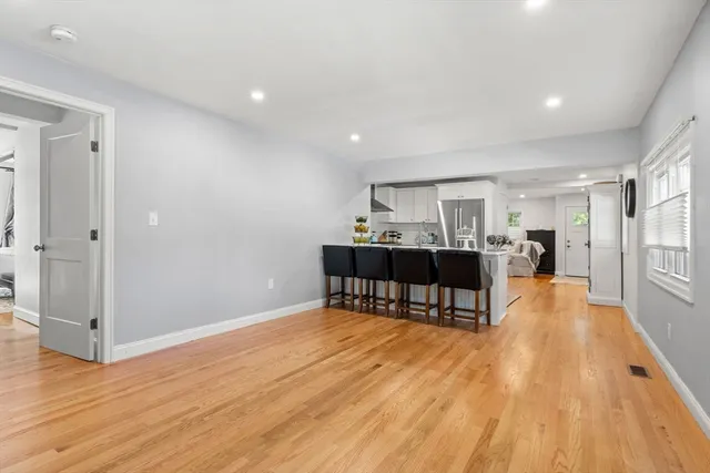 a view of an empty room with a fireplace and a window