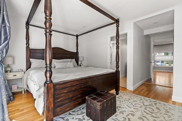 a bed sitting in a bedroom next to a window