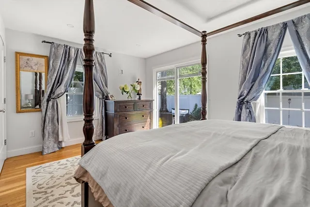 a bedroom with a bed and a large window