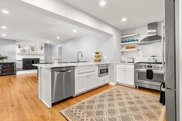 a kitchen with a stove sink and cabinets