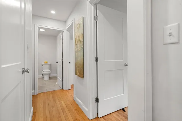 a view of a hallway with wooden floor and entryway