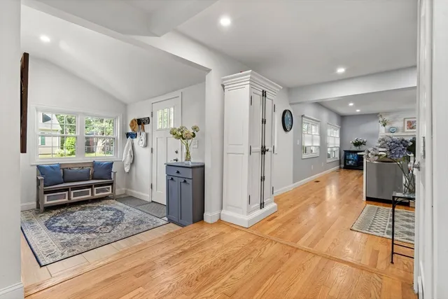 a view of a house with a big yard and large trees
