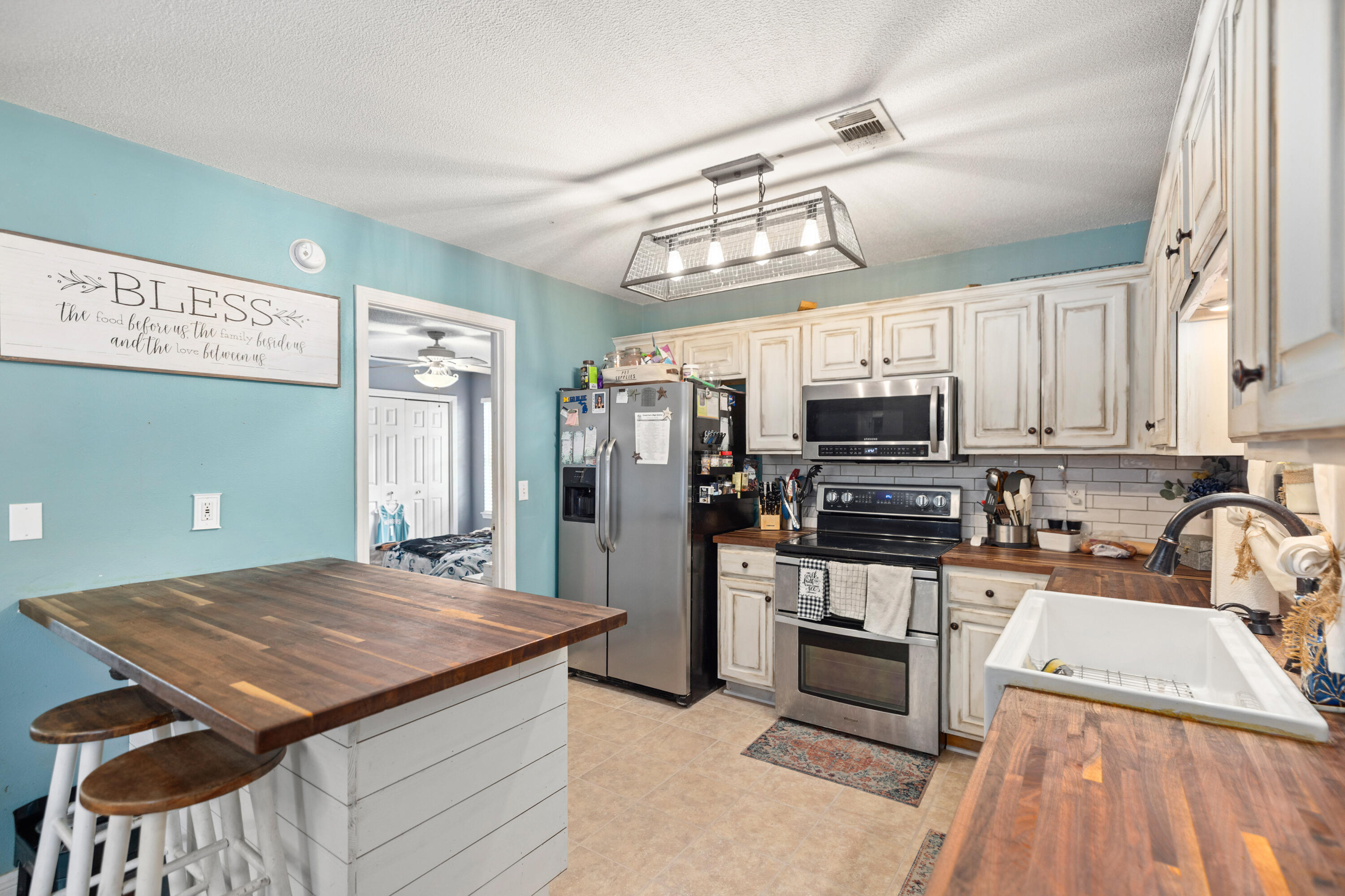 204 Warrior Street Crestview, FL 32536 - Photo 11 of 58 a kitchen with kitchen island a large counter top space appliances and cabinets