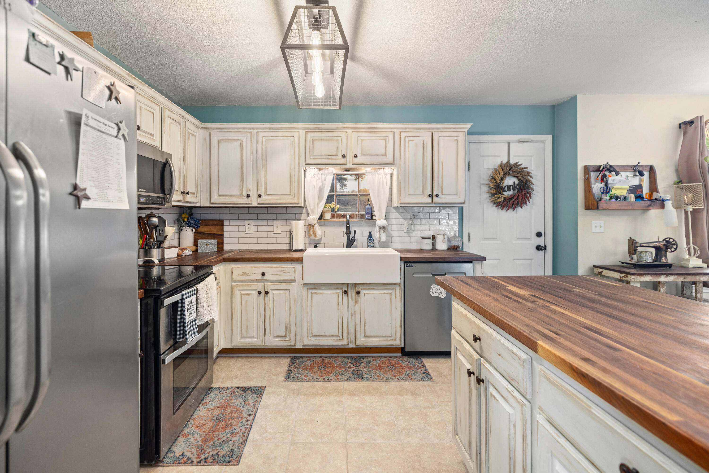 204 Warrior Street Crestview, FL 32536 - Photo 13 of 59 a kitchen with stainless steel appliances granite countertop a sink a stove and refrigerator
