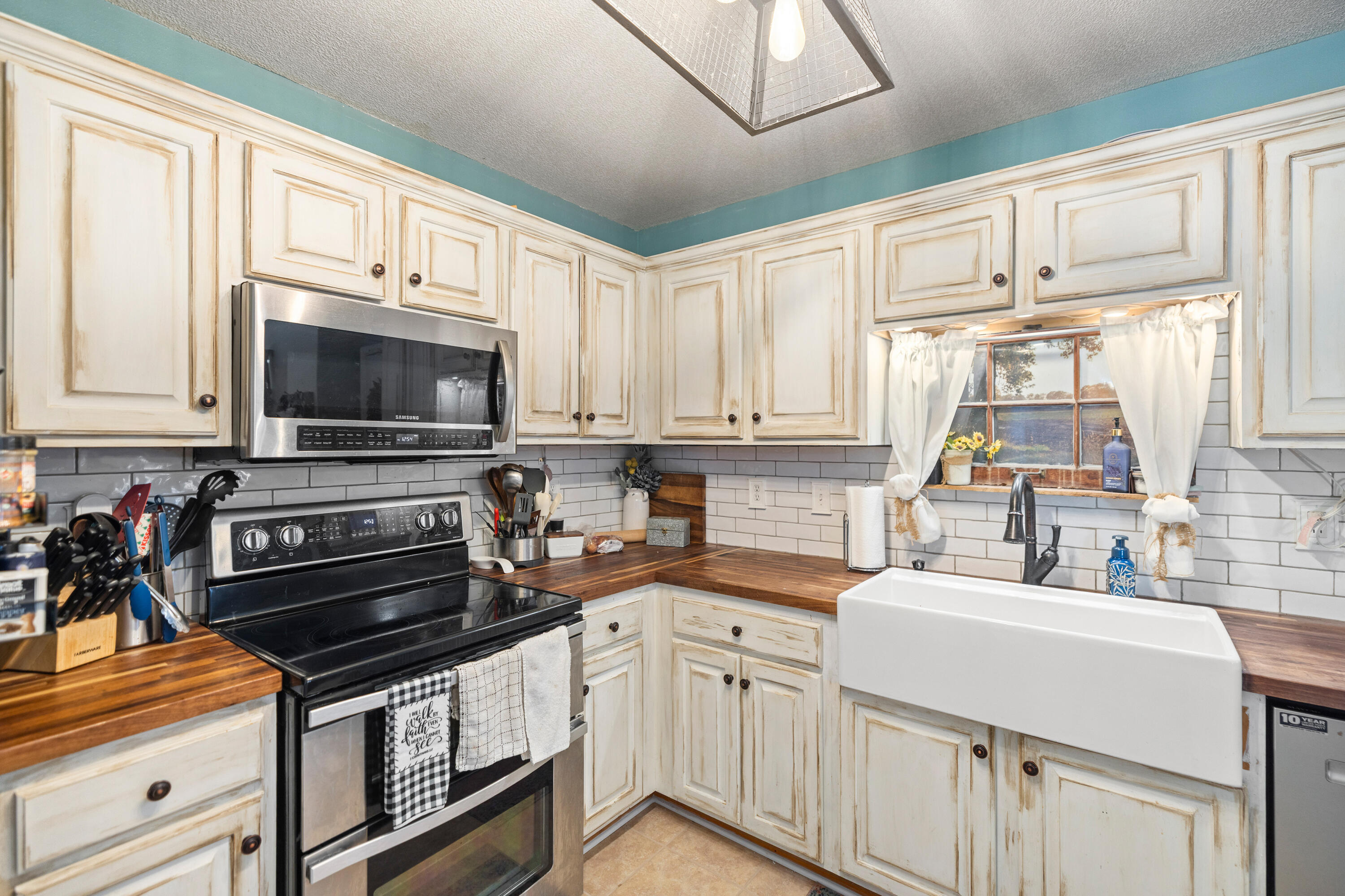 204 Warrior Street Crestview, FL 32536 - Photo 13 of 58 a kitchen with appliances a sink and cabinets