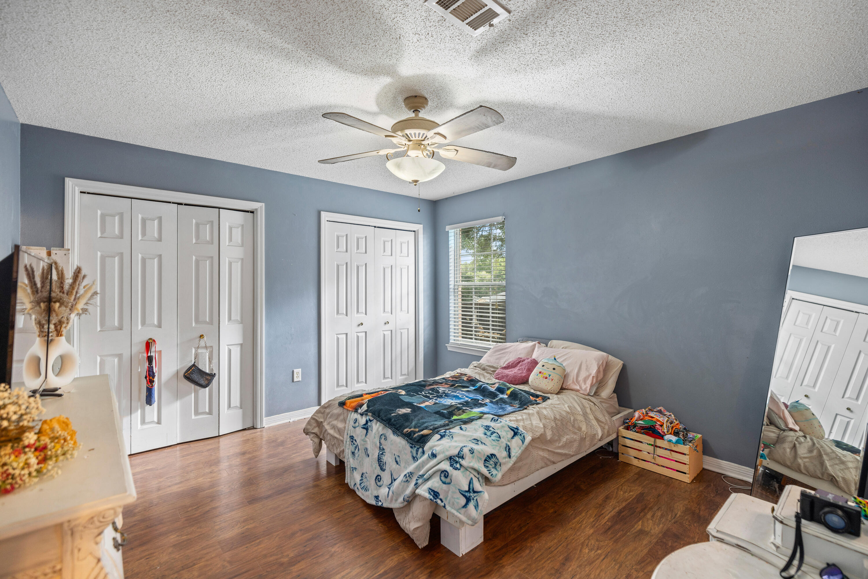 204 Warrior Street Crestview, FL 32536 - Photo 16 of 58 a bedroom with a bed and a chandelier