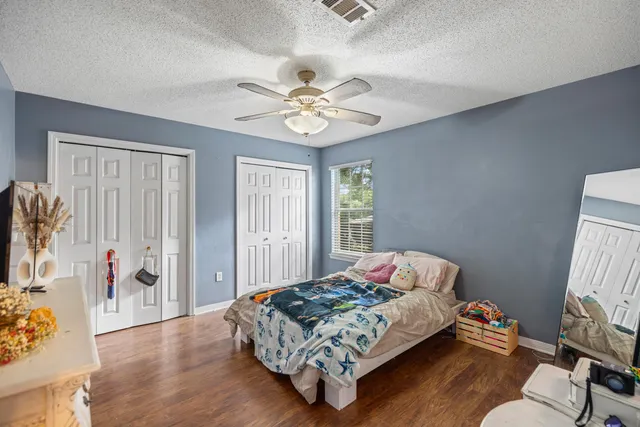 a bedroom with furniture and a flat screen tv