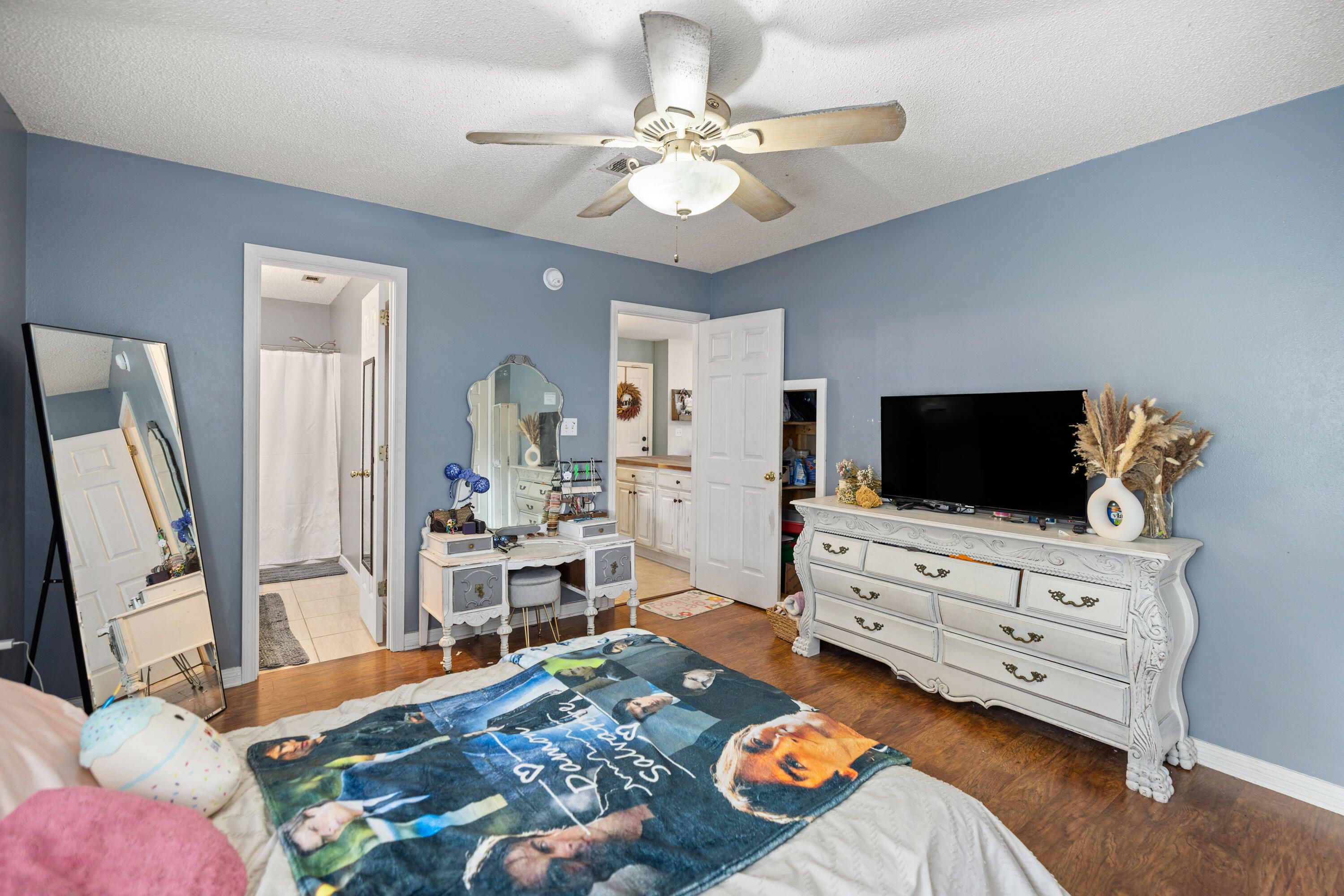 204 Warrior Street Crestview, FL 32536 - Photo 17 of 58 a bedroom with furniture and a flat screen tv