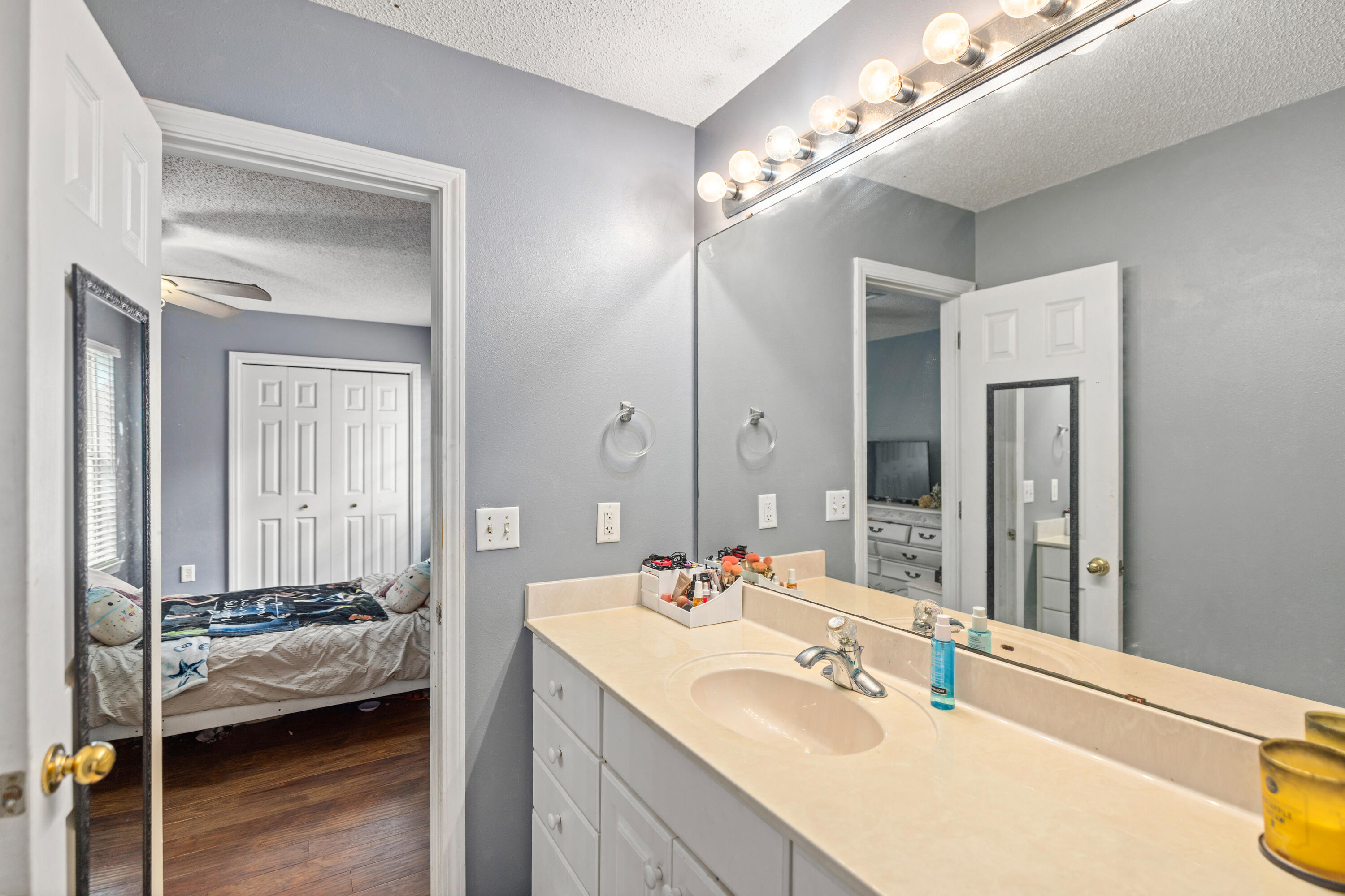 204 Warrior Street Crestview, FL 32536 - Photo 19 of 58 a en suite bathroom with a sink and a mirror