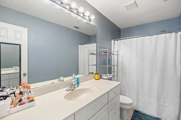 a en suite bathroom with a sink and a mirror