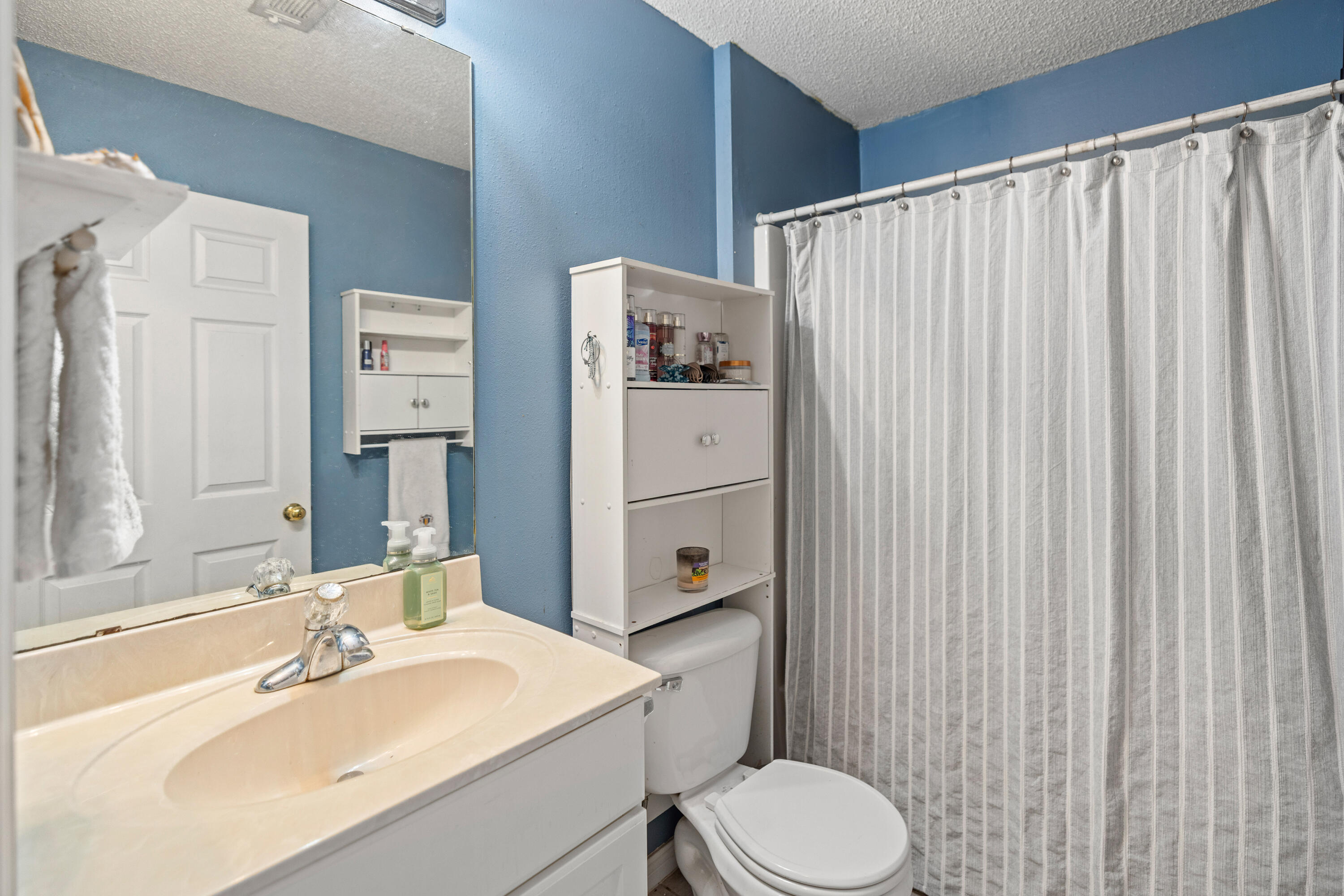 204 Warrior Street Crestview, FL 32536 - Photo 23 of 58 a bathroom with a sink toilet and shower