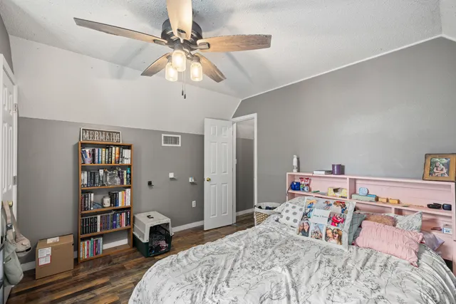 a bedroom with a bed and lamp chandelier