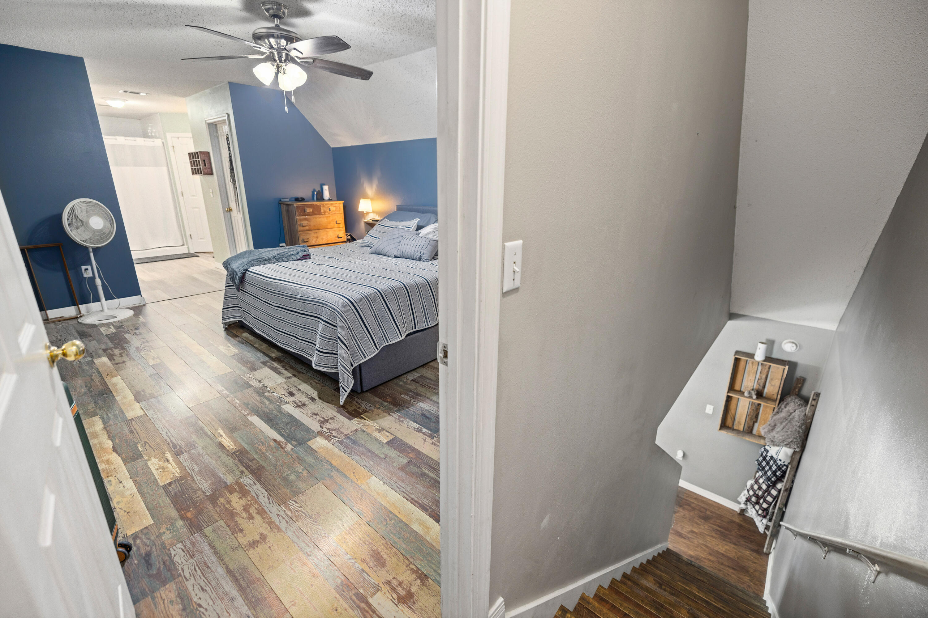 204 Warrior Street Crestview, FL 32536 - Photo 31 of 59 a bedroom with a bed and wooden floor