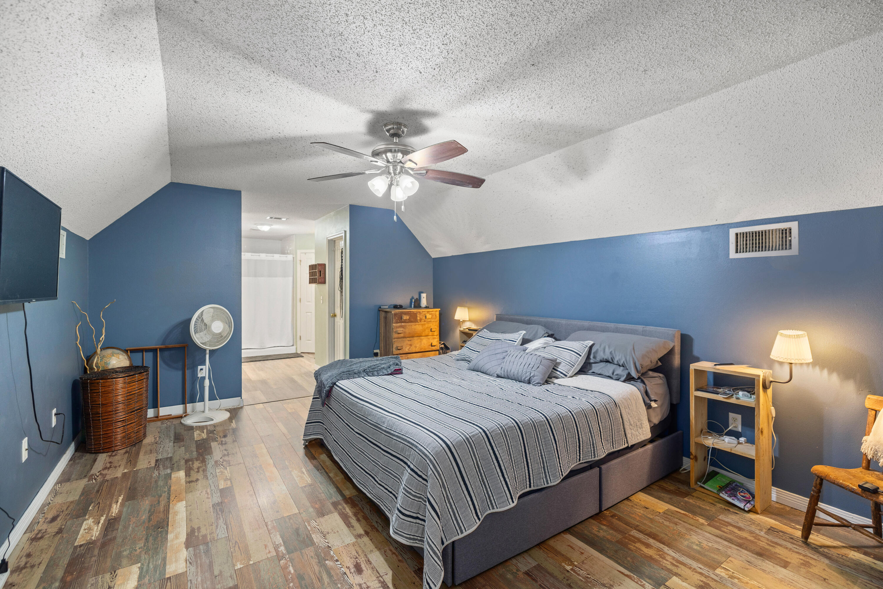 204 Warrior Street Crestview, FL 32536 - Photo 31 of 58 a bedroom with a bed and lamp chandelier