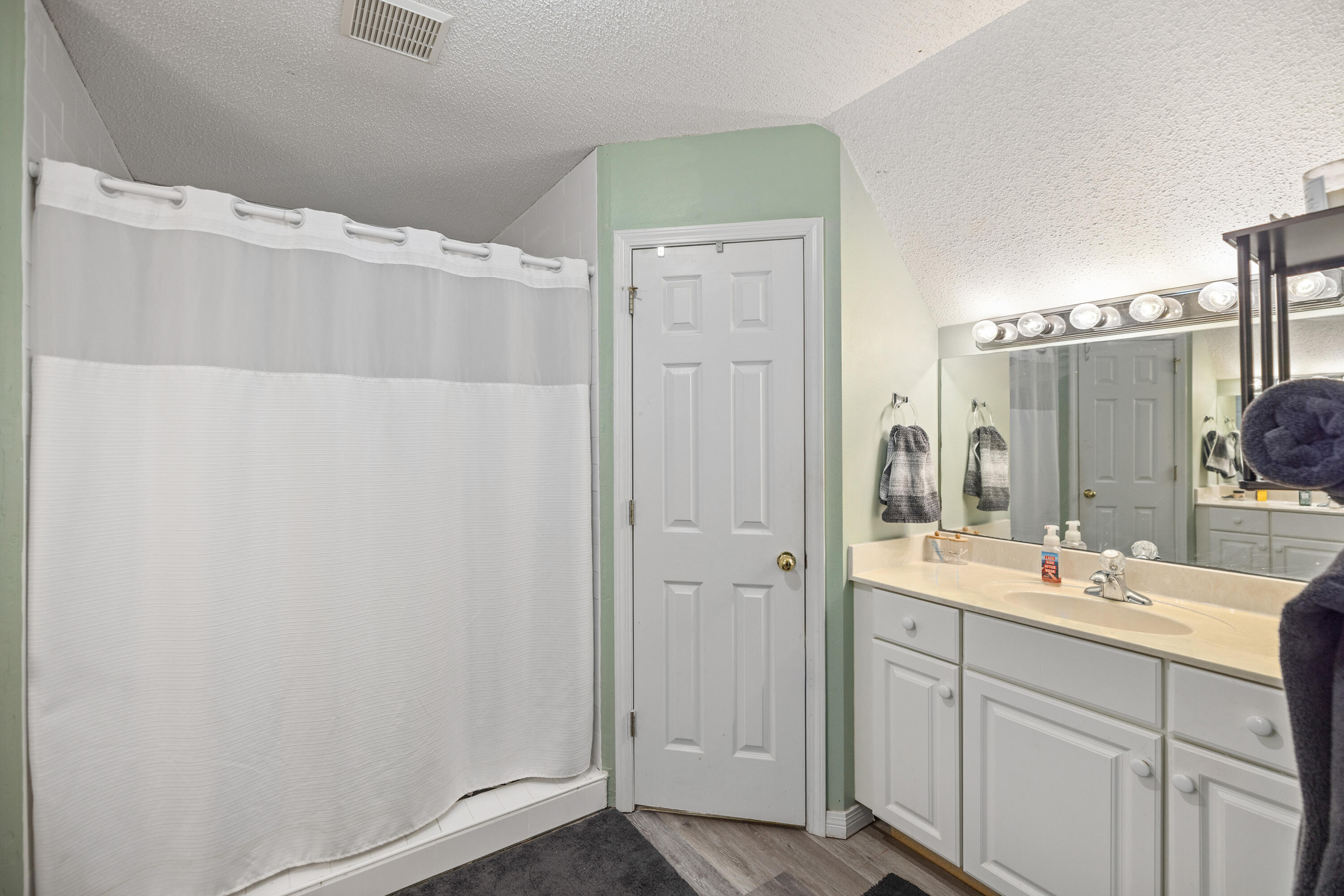 204 Warrior Street Crestview, FL 32536 - Photo 34 of 58 a bathroom with a double vanity sink and mirror