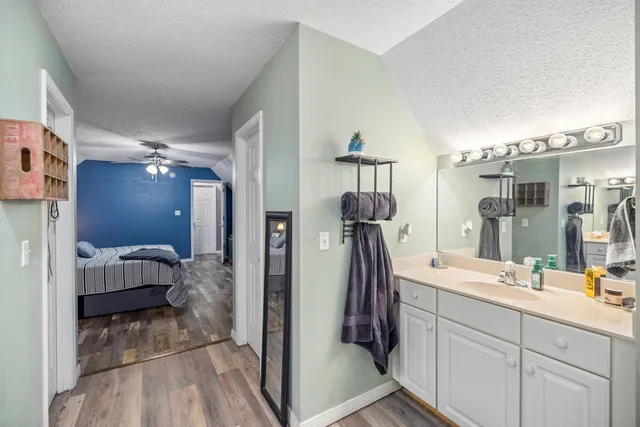 a view of bathroom with a sink mirror and shower
