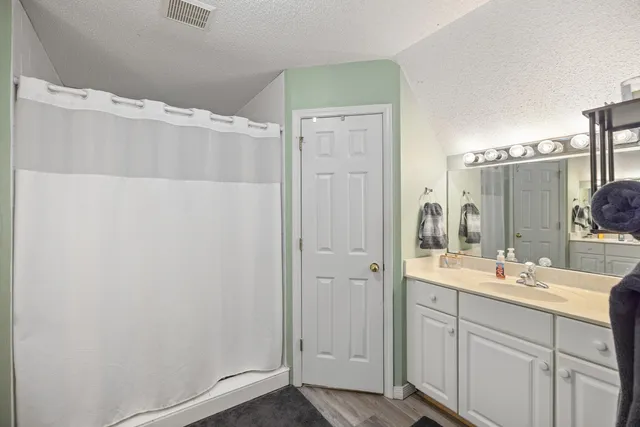 a bathroom with a double vanity sink and mirror