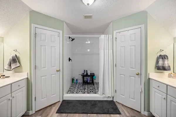 a view of walk in closet with clothes