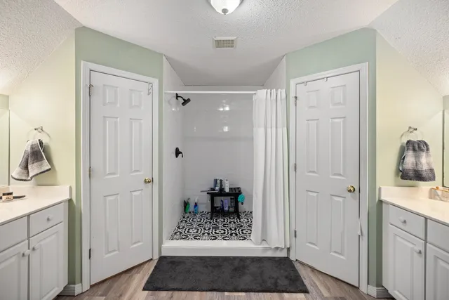 a view of walk in closet with clothes