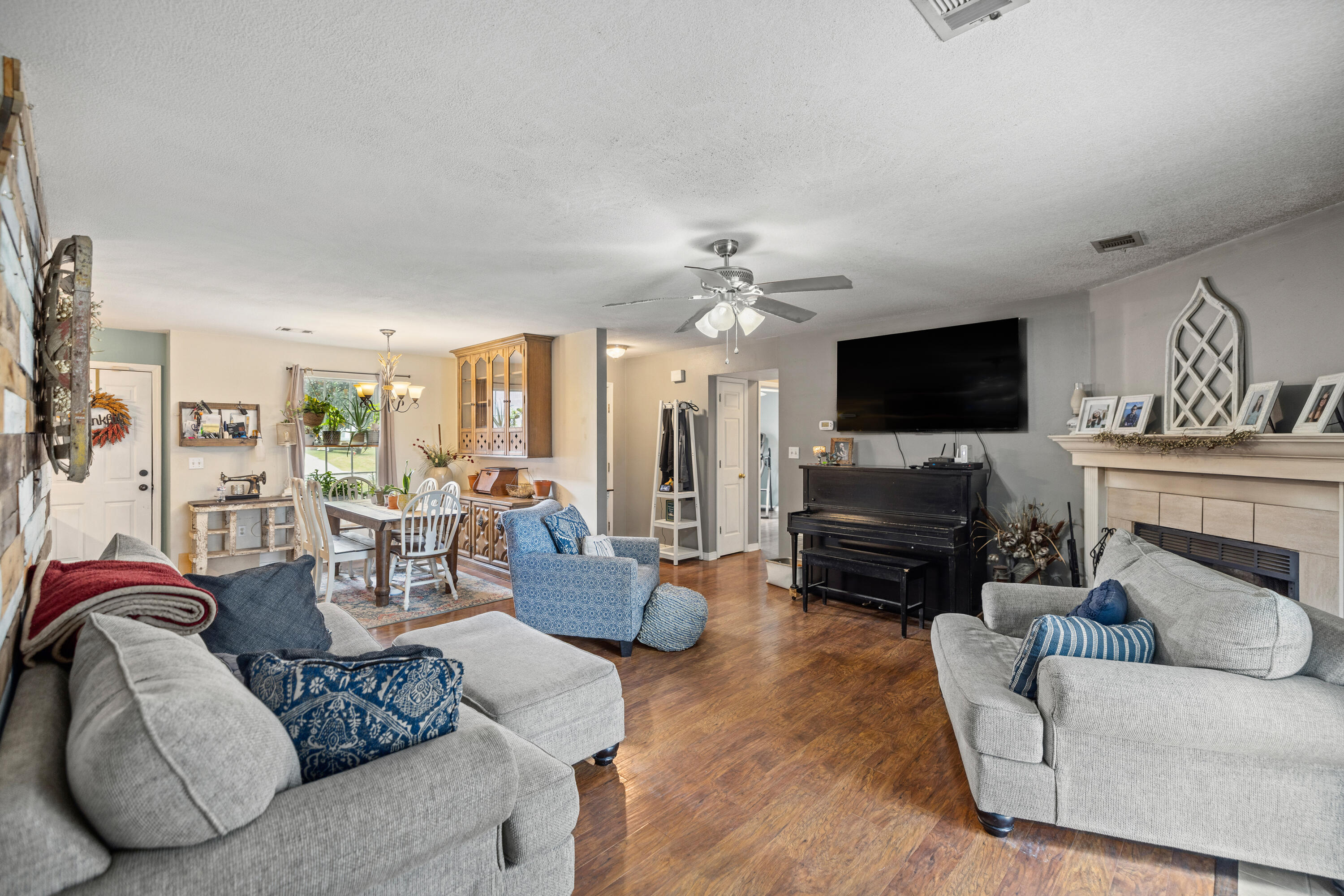 204 Warrior Street Crestview, FL 32536 - Photo 4 of 58 a living room with furniture and a flat screen tv