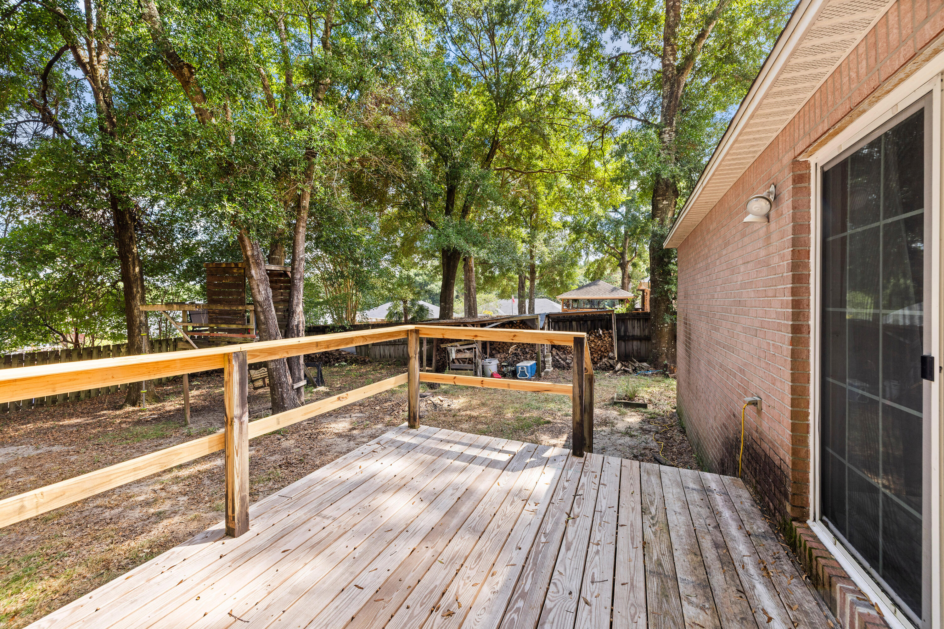 204 Warrior Street Crestview, FL 32536 - Photo 41 of 58 a view of a balcony with wooden floor and fence