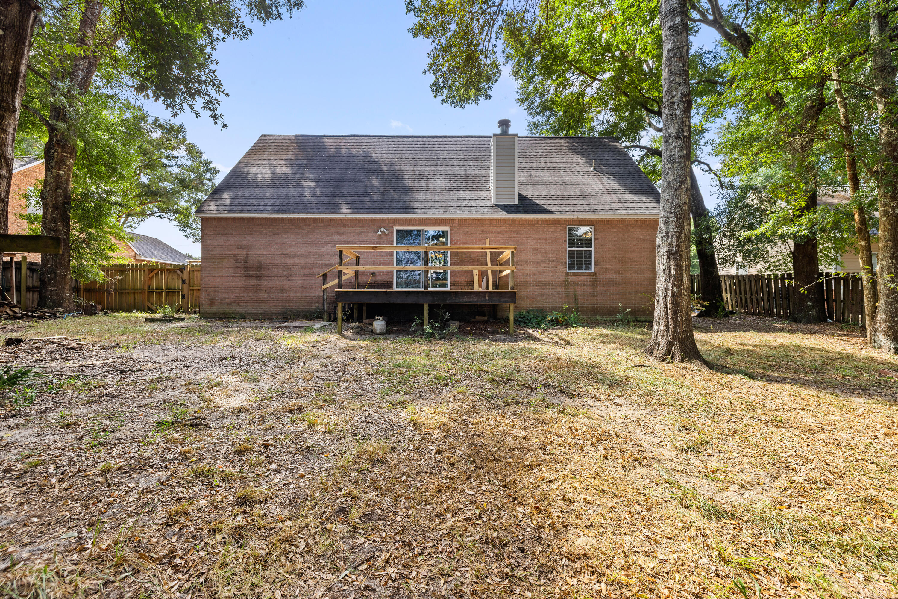 204 Warrior Street Crestview, FL 32536 - Photo 43 of 58 a backyard of a house with table and chairs