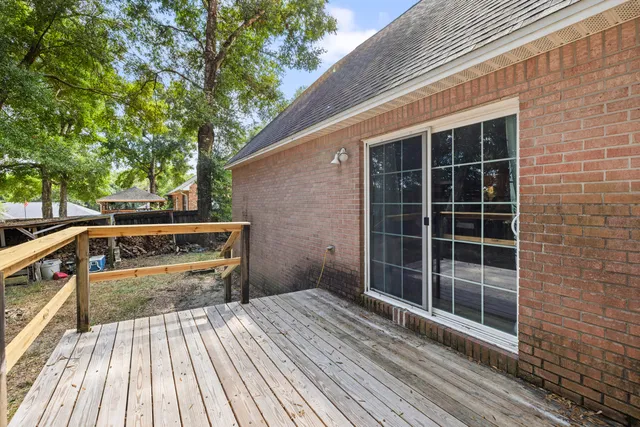 a view of a chair and table in backyard of the house