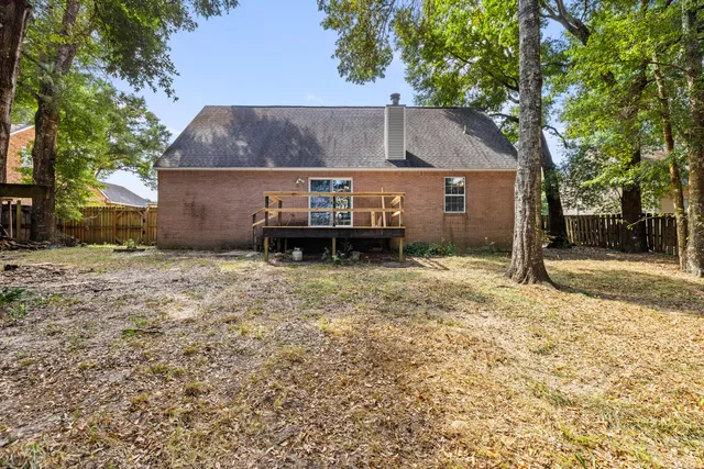 a view of a backyard with table and potted plants