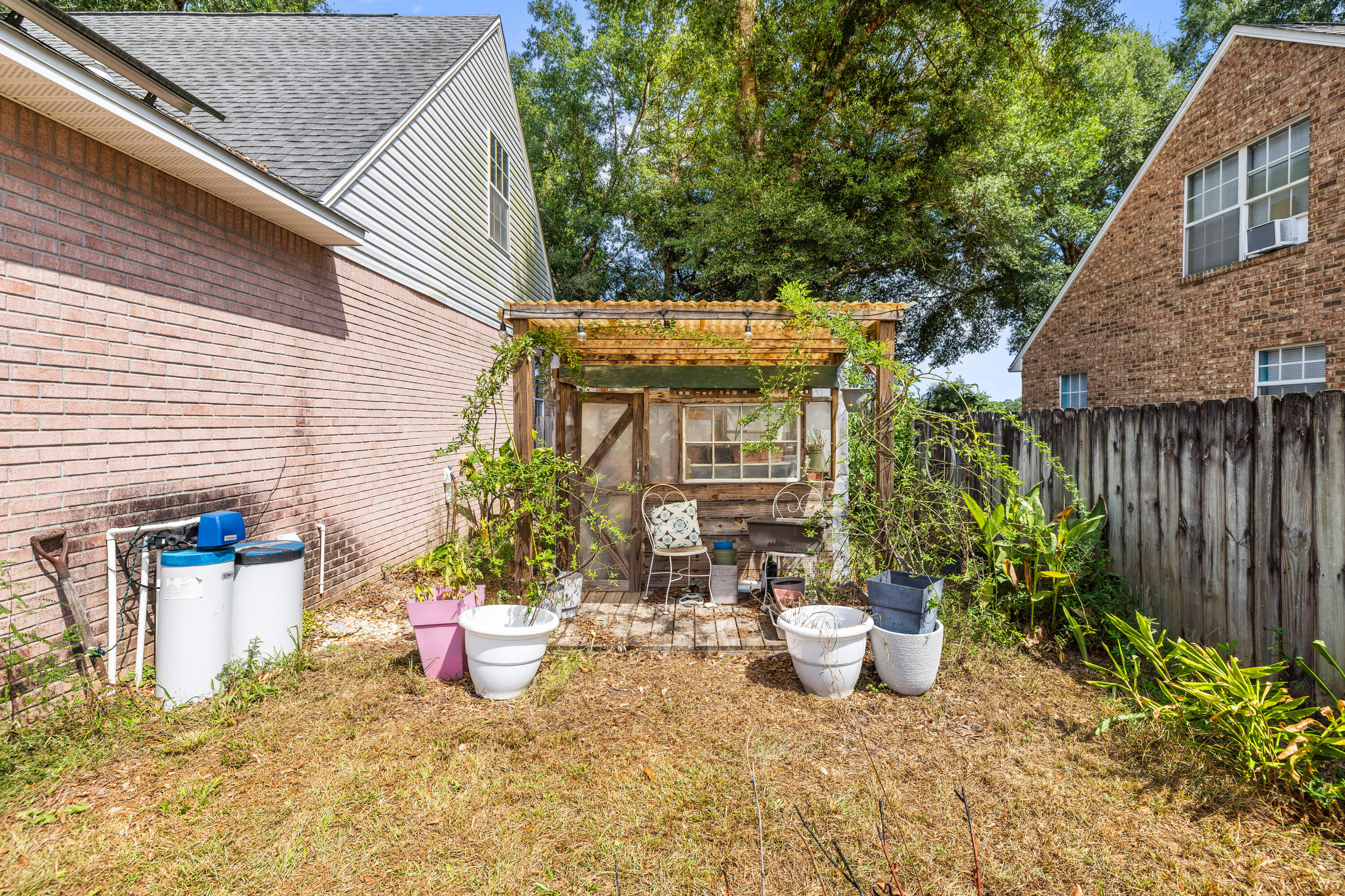 204 Warrior Street Crestview, FL 32536 - Photo 47 of 59 a view of a chair and table in backyard of the house