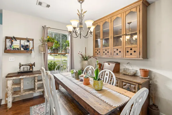 a living room with furniture a fireplace and a chandelier