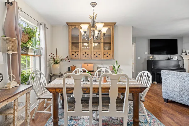 a kitchen with stainless steel appliances granite countertop a sink a stove a refrigerator cabinets and living room view