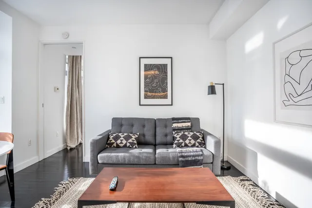 a kitchen with a sink a stove cabinets and wooden floor