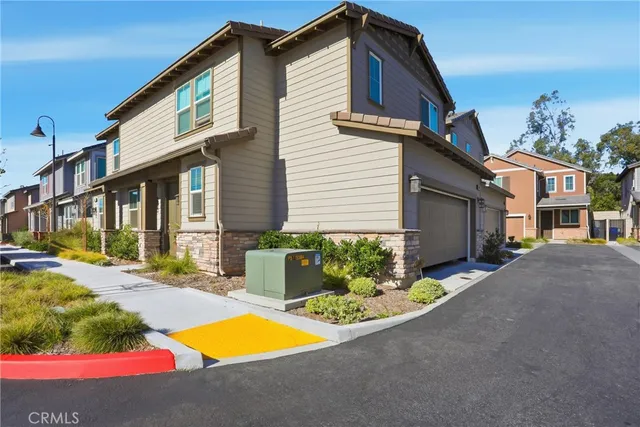 a front view of a house with a yard and outdoor seating