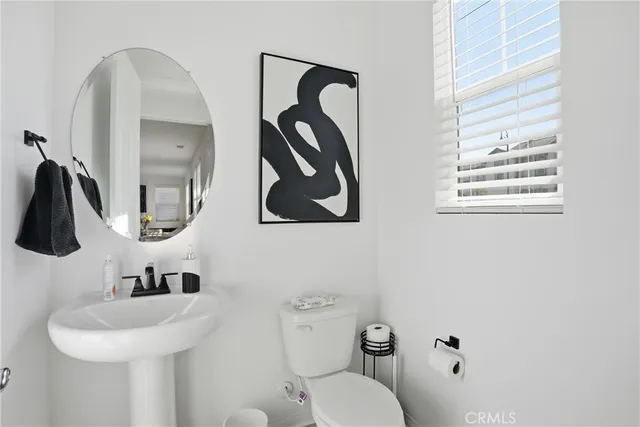 a view of staircase with white walls and a window