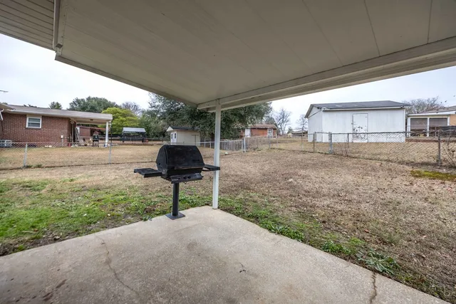 a view of a backyard with table and chairs