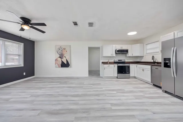 a view of kitchen with microwave and cabinets